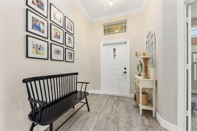 foyer entrance featuring ornamental molding and light wood-type flooring