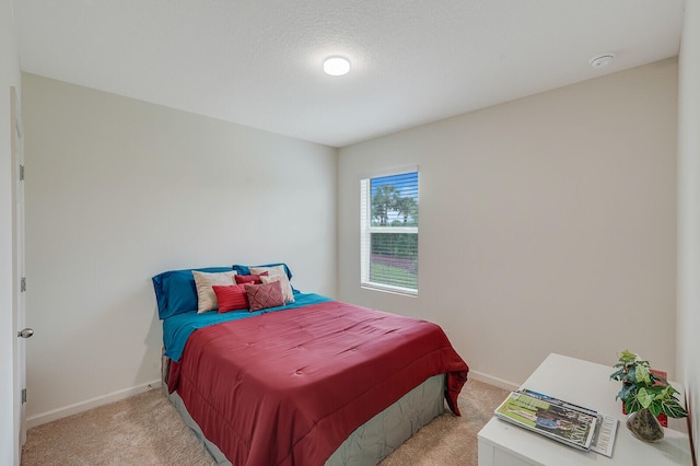 carpeted bedroom featuring a textured ceiling