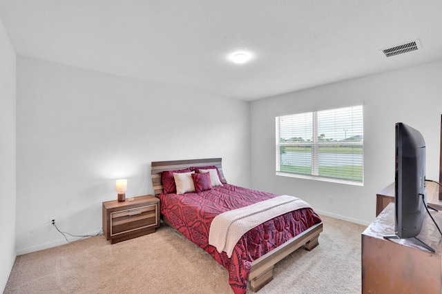 bedroom with light colored carpet