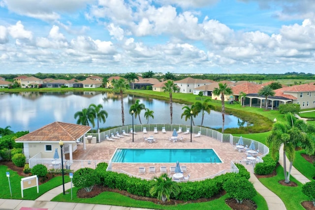 view of swimming pool featuring a water view and a patio area