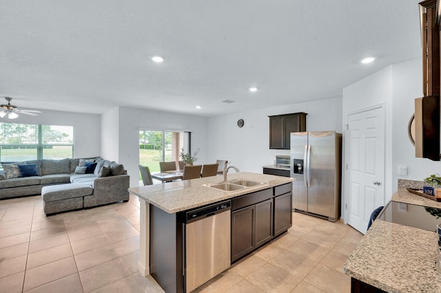 kitchen with dark brown cabinetry, an island with sink, appliances with stainless steel finishes, and sink