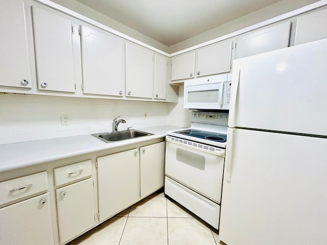 kitchen with light tile patterned floors, white appliances, white cabinetry, and sink