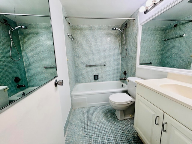 full bathroom with tile patterned flooring, vanity, tiled shower / bath combo, and toilet