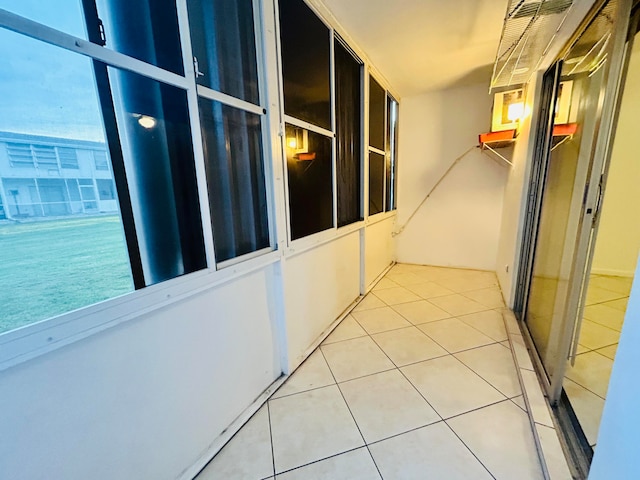 hallway with tile patterned floors