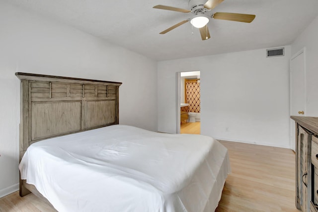 bedroom featuring ensuite bathroom, light wood-type flooring, and ceiling fan