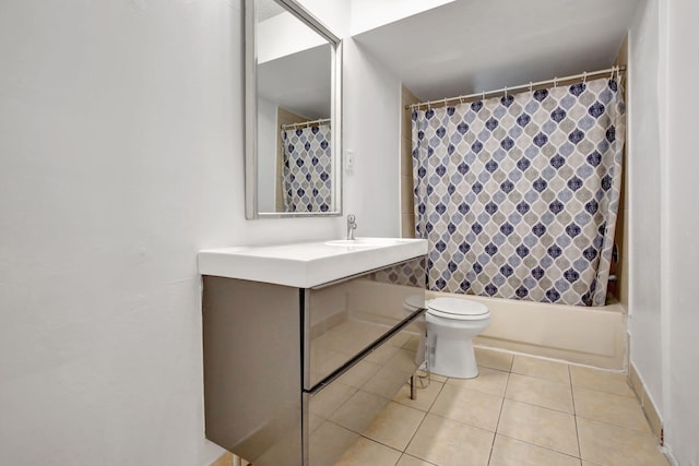 full bathroom with vanity, shower / bath combo with shower curtain, toilet, and tile patterned flooring