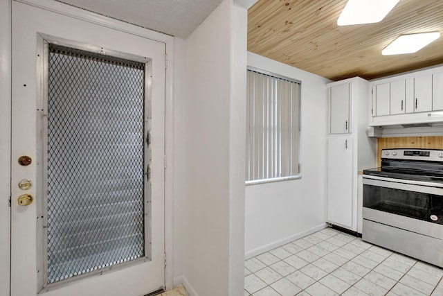 kitchen featuring white cabinetry, stainless steel electric range, and light tile patterned flooring