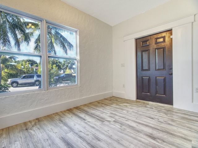 entryway featuring a textured wall and wood finished floors