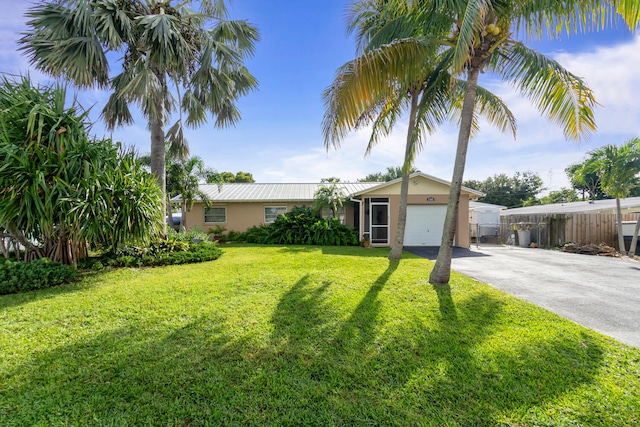 view of front of property featuring a front yard and a garage