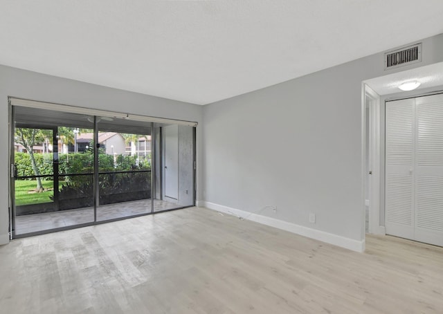 unfurnished room featuring light hardwood / wood-style floors