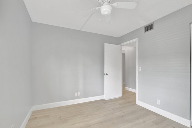 empty room featuring ceiling fan and light hardwood / wood-style flooring