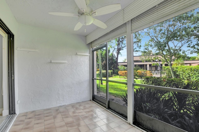 unfurnished sunroom featuring ceiling fan