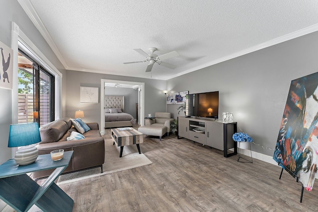 411 4th Ter, Palm Beach Gardens, FL 33418 - living area featuring a textured ceiling, a ceiling fan, wood finished floors, crown molding, and baseboards
