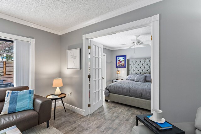 411 4th Ter, Palm Beach Gardens, FL 33418 - bedroom with wood finished floors, a textured ceiling, crown molding, baseboards, and ceiling fan