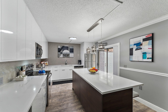 411 4th Ter, Palm Beach Gardens, FL 33418 - kitchen featuring stainless steel appliances, modern cabinets, dark wood-style floors, light countertops, and white cabinets