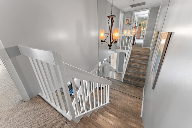 411 4th Ter, Palm Beach Gardens, FL 33418 - staircase featuring a chandelier and wood finished floors