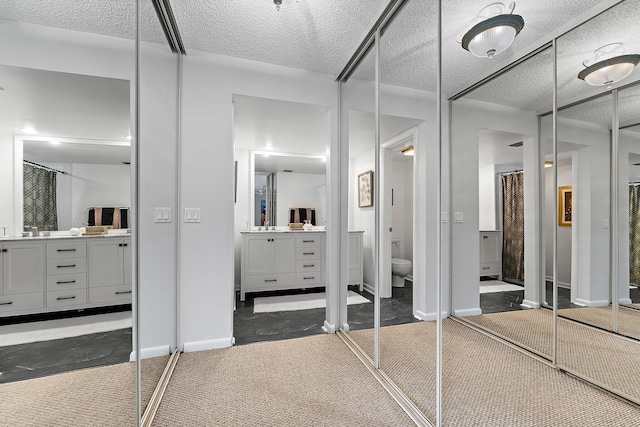 411 4th Ter, Palm Beach Gardens, FL 33418 - full bath with vanity, toilet, baseboards, a textured ceiling, and curtained shower