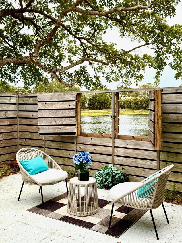411 4th Ter, Palm Beach Gardens, FL 33418 - view of patio / terrace with a water view and fence