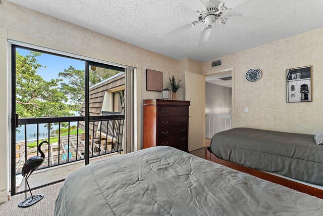 411 4th Ter, Palm Beach Gardens, FL 33418 - carpeted bedroom with access to outside, a textured ceiling, and ceiling fan