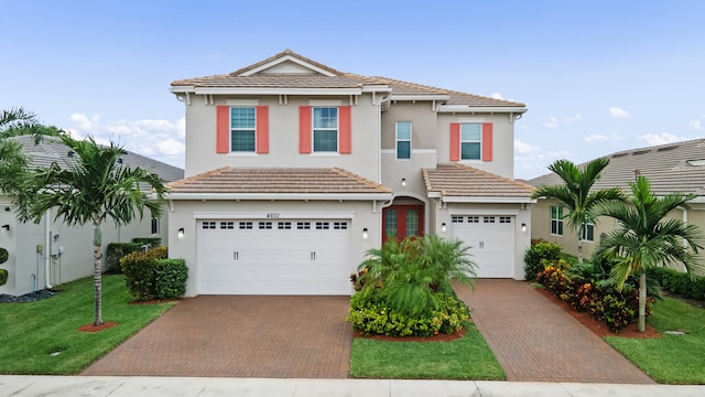 view of front of property with a garage and a front yard