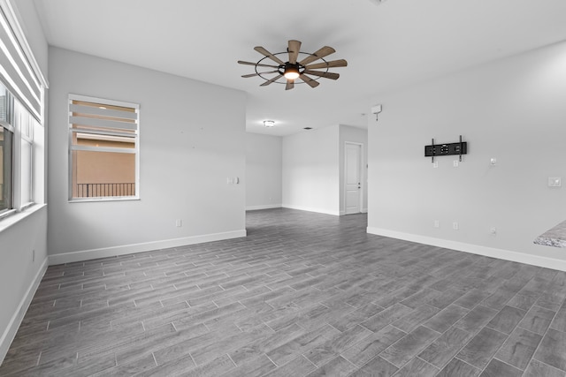 empty room with ceiling fan and hardwood / wood-style flooring