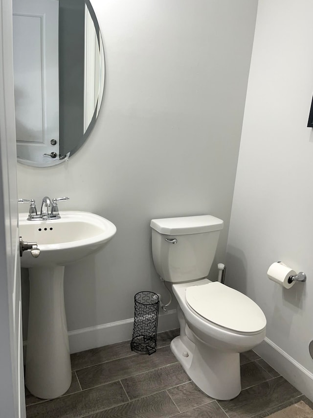 bathroom featuring hardwood / wood-style floors and toilet