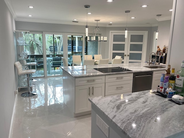 kitchen with light stone counters, hanging light fixtures, stainless steel dishwasher, white cabinetry, and black electric stovetop