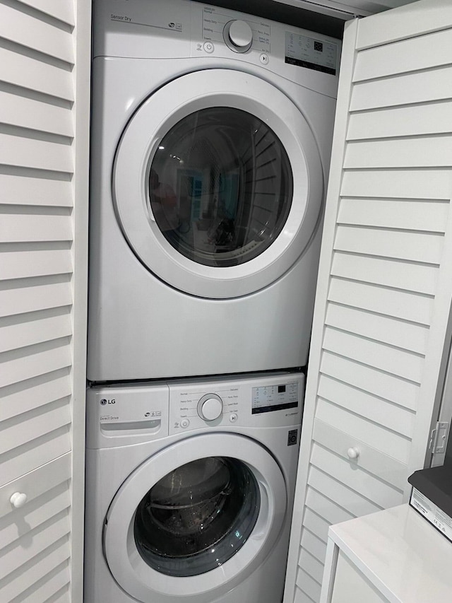 washroom featuring stacked washer and dryer