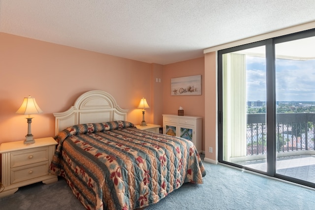 bedroom with multiple windows, a textured ceiling, carpet floors, and access to exterior