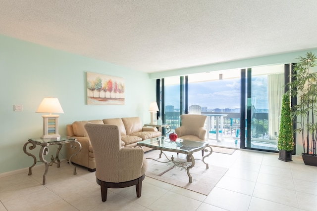 living room featuring a wealth of natural light, a textured ceiling, and a wall of windows