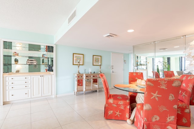 dining area with light tile patterned floors