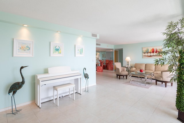 interior space featuring a textured ceiling and light tile patterned floors