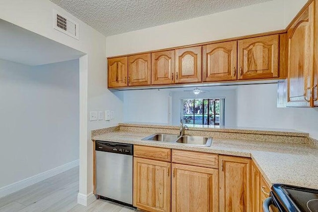 kitchen with light hardwood / wood-style floors, sink, a textured ceiling, dishwasher, and black range oven