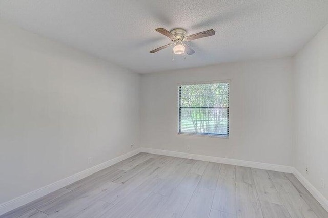 empty room with light wood-type flooring, a textured ceiling, and ceiling fan