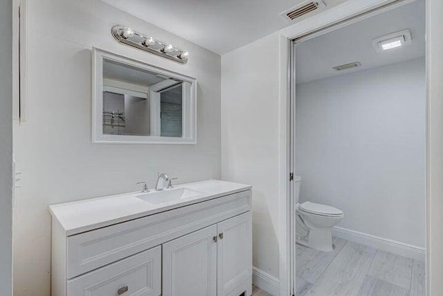 bathroom with vanity and toilet