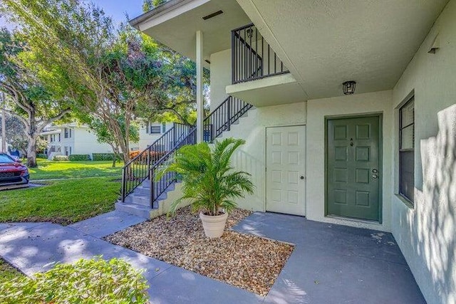 property entrance with a yard