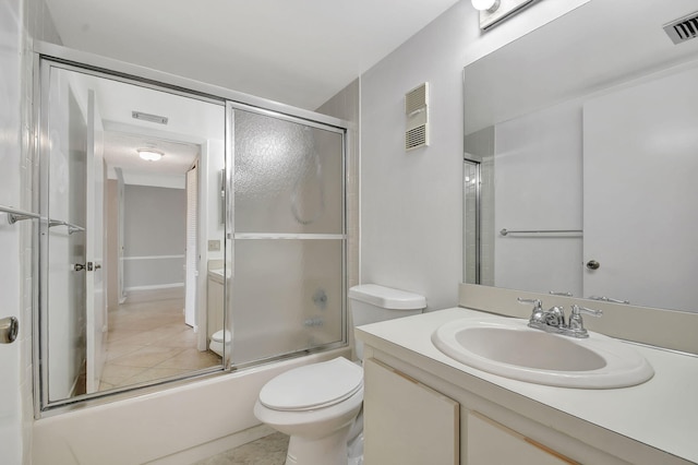 full bathroom featuring bath / shower combo with glass door, vanity, and toilet