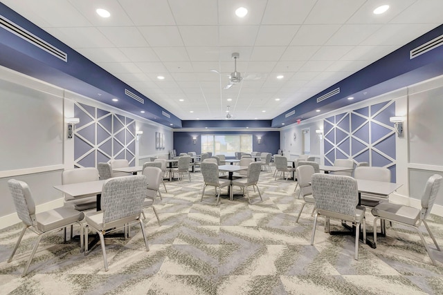 dining room with ceiling fan and carpet