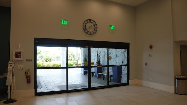 interior space featuring a high ceiling and light tile patterned floors