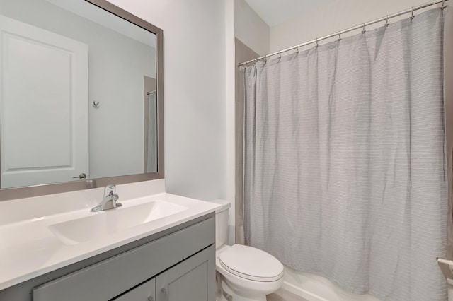 full bathroom with shower / bath combo, vanity, and toilet