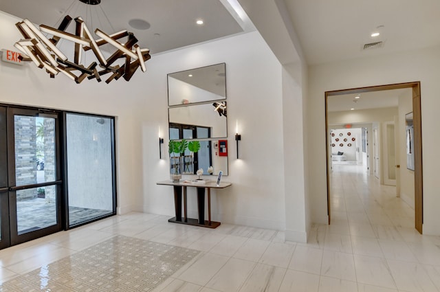 corridor featuring an inviting chandelier and light tile patterned flooring