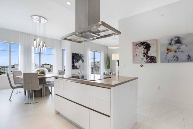 kitchen featuring black electric cooktop, white cabinets, island range hood, a kitchen island, and pendant lighting