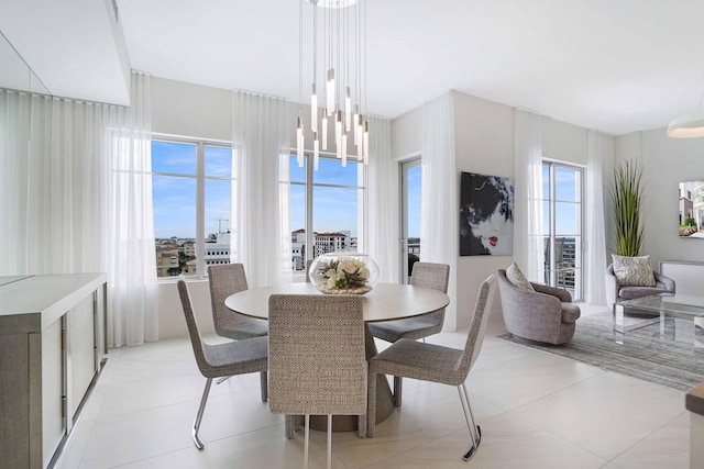 dining area featuring an inviting chandelier, a wealth of natural light, and light tile patterned flooring