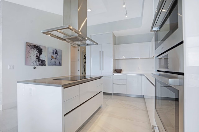 kitchen featuring white cabinets, island range hood, a kitchen island, and black electric cooktop