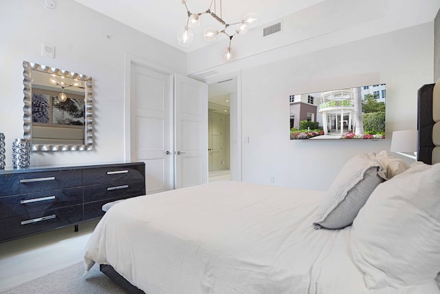 bedroom with a chandelier and carpet flooring