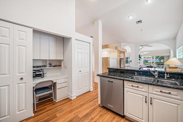 kitchen featuring light hardwood / wood-style flooring, dishwasher, dark stone countertops, and ceiling fan