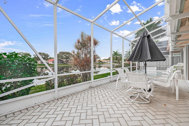 unfurnished sunroom featuring a water view