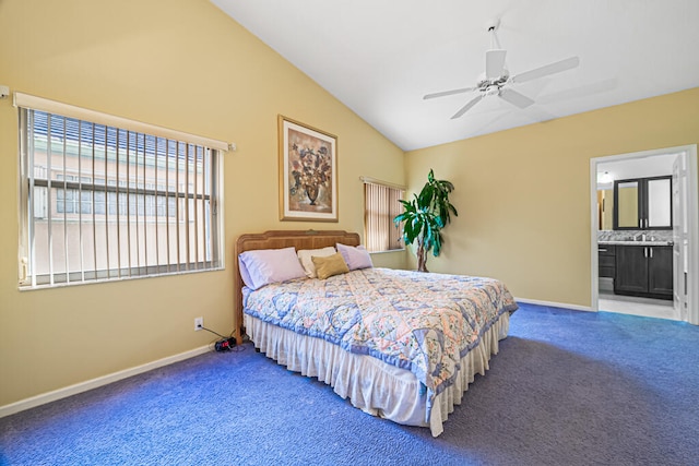 carpeted bedroom featuring lofted ceiling, ensuite bath, and ceiling fan