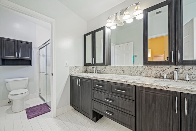 bathroom with toilet, an enclosed shower, vanity, and tile patterned floors