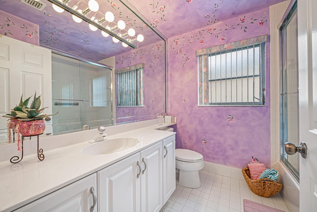 full bathroom with vanity, toilet, tile patterned floors, and combined bath / shower with glass door